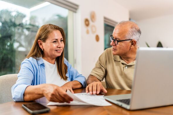 Senior couple talking while doing home finance