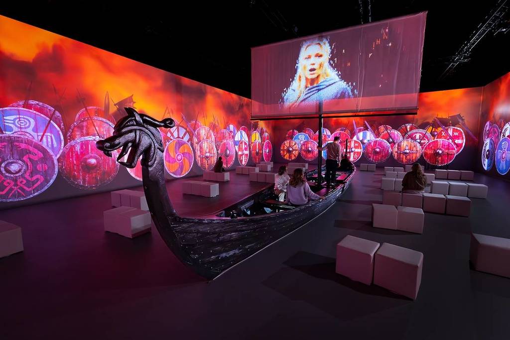 a recreatipm of a viking longship sits in an immersive room at Vikings: The Immersive Experience