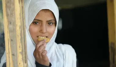 A student enjoys a fortified biscuit provided by the World Food Programme in Afghanistan. (Photo Credit: WFP)