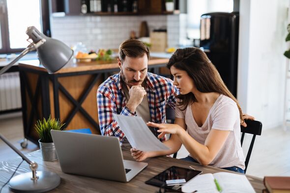 Young couple looking at their pension plan
