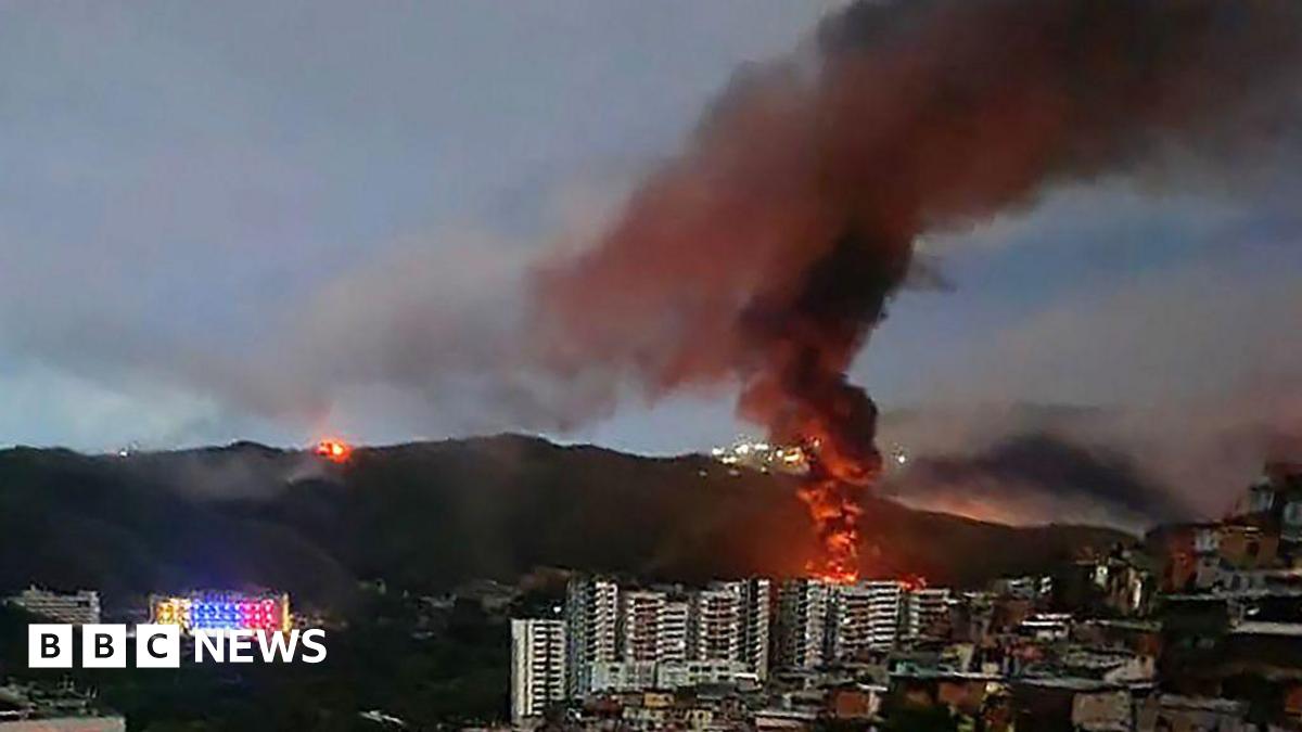 Fire at Fuerte Tiuna, Venezuela's largest military complex, is seen from a distance after a series of explosions in Caracas