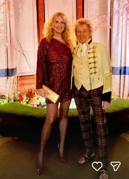 Penny Lancaster and Rod Stewart posing together at an event.