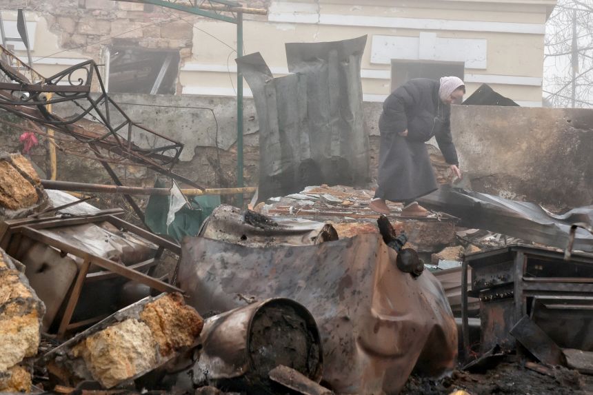 A woman stands among the debris at the Holy Dormition Male Monastery damaged by a Russian drone attack in Odesa, Ukraine, on Wednesday, January 28.