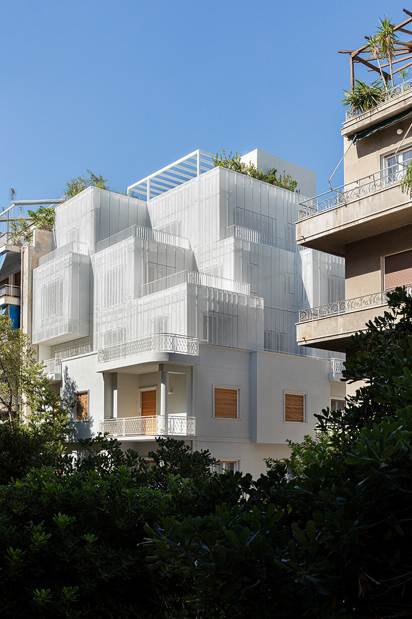 layered lightweight volumes by arid extend 1950s building in patissia, athens