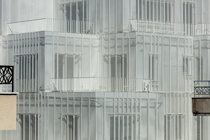 layered lightweight volumes by arid extend 1950s building in patissia, athens