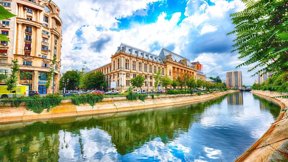 Antique building view in Old Town Bucharest city - capital of Romania and Dambrovita river. Bucharest, Romania, Europe.