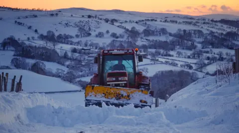 Ruth Davies / Weather Watchers A snow plough at sunrise in Llandegla, Denbighshire