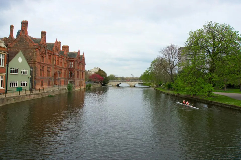 People Rowing a Boat on the River in Bedford