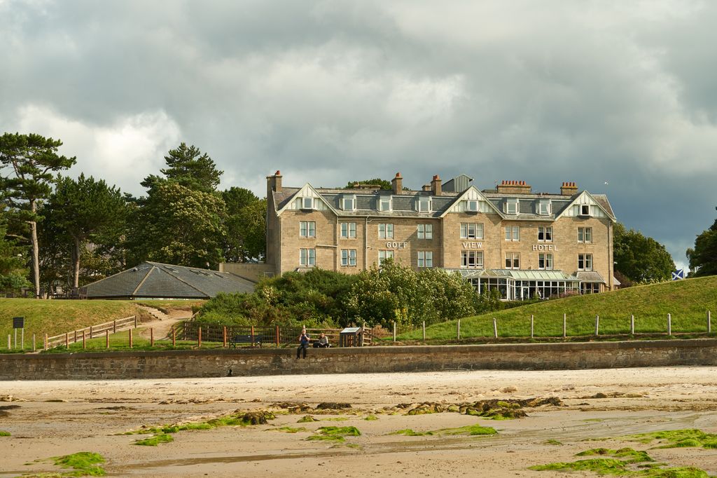 A hotel on the side of a beach