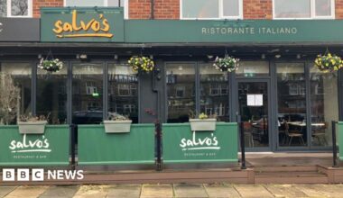 Salvo's Italian restaurant and bar in Leeds, which has a glass font and dark green signage with yellow writing.