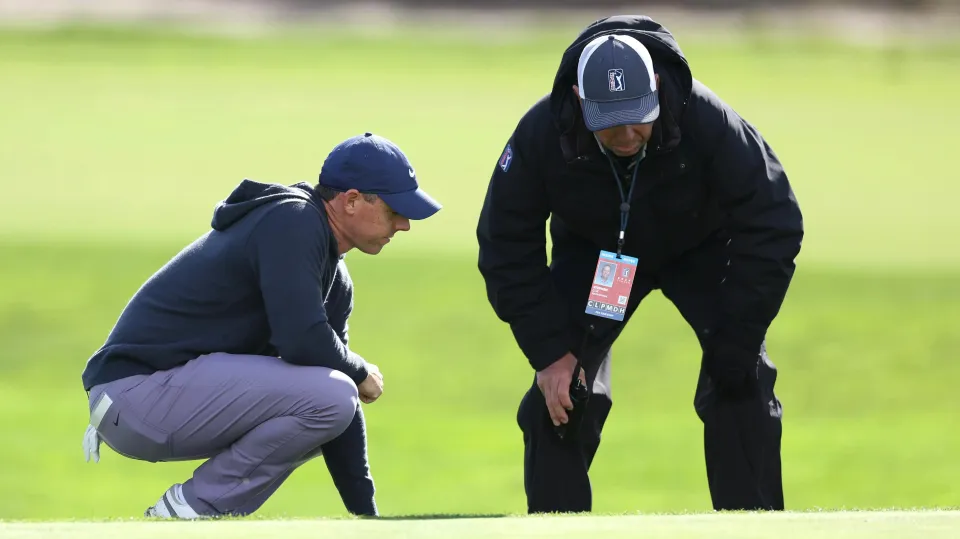 Rory McIlroy talks to official during Pebble Beach Pro-Am