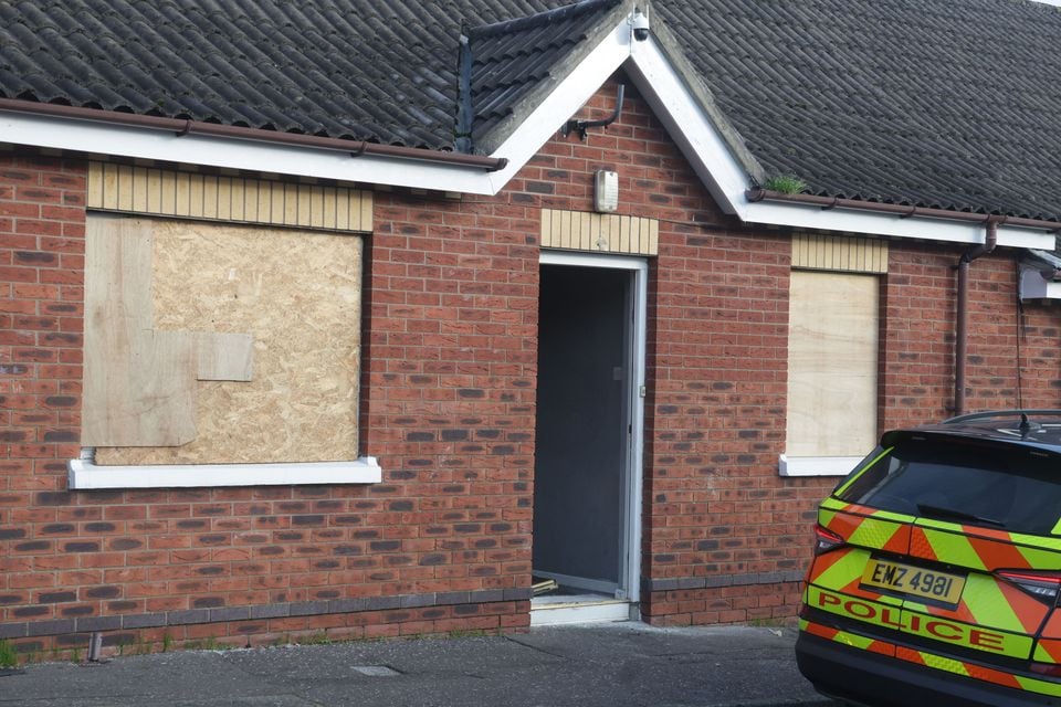 The house on Ceylon Street in north Belfast with its windows boarded up and a police car outside (Photo by Pacemaker)