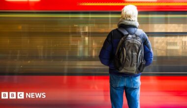 Prime Minister Mark Carney, wearing a black suit jacket, and a white button-up shirt leans his chin on his hands. He has short grey and black hair and is looking away from the camera.