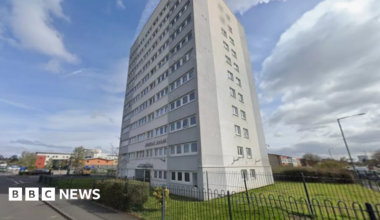 A Google Streetview image showing a light grey tower block known as Merton House.