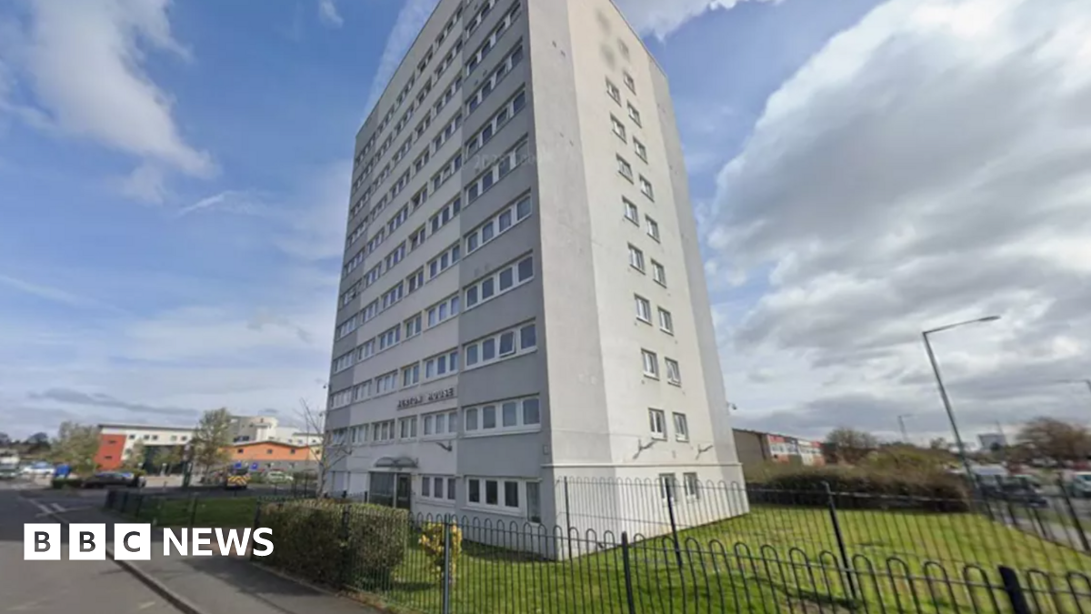 A Google Streetview image showing a light grey tower block known as Merton House.