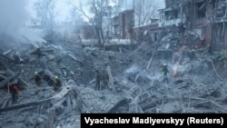 Rescue teams work at the site of an apartment hit by a Russian strike on January 2.