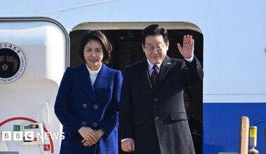 Woman and man alighting from airplane