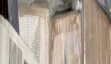 Several rectangular white blocks of cocaine inside a grey bag. Each block is wrapped in clear plastic over brown packaging.