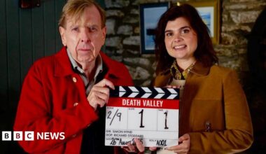 Timothy Spall, who plays John Chapel and Gwyneth Keyworth, who plays, Janie Mallowan holding a production slate for Death Valley