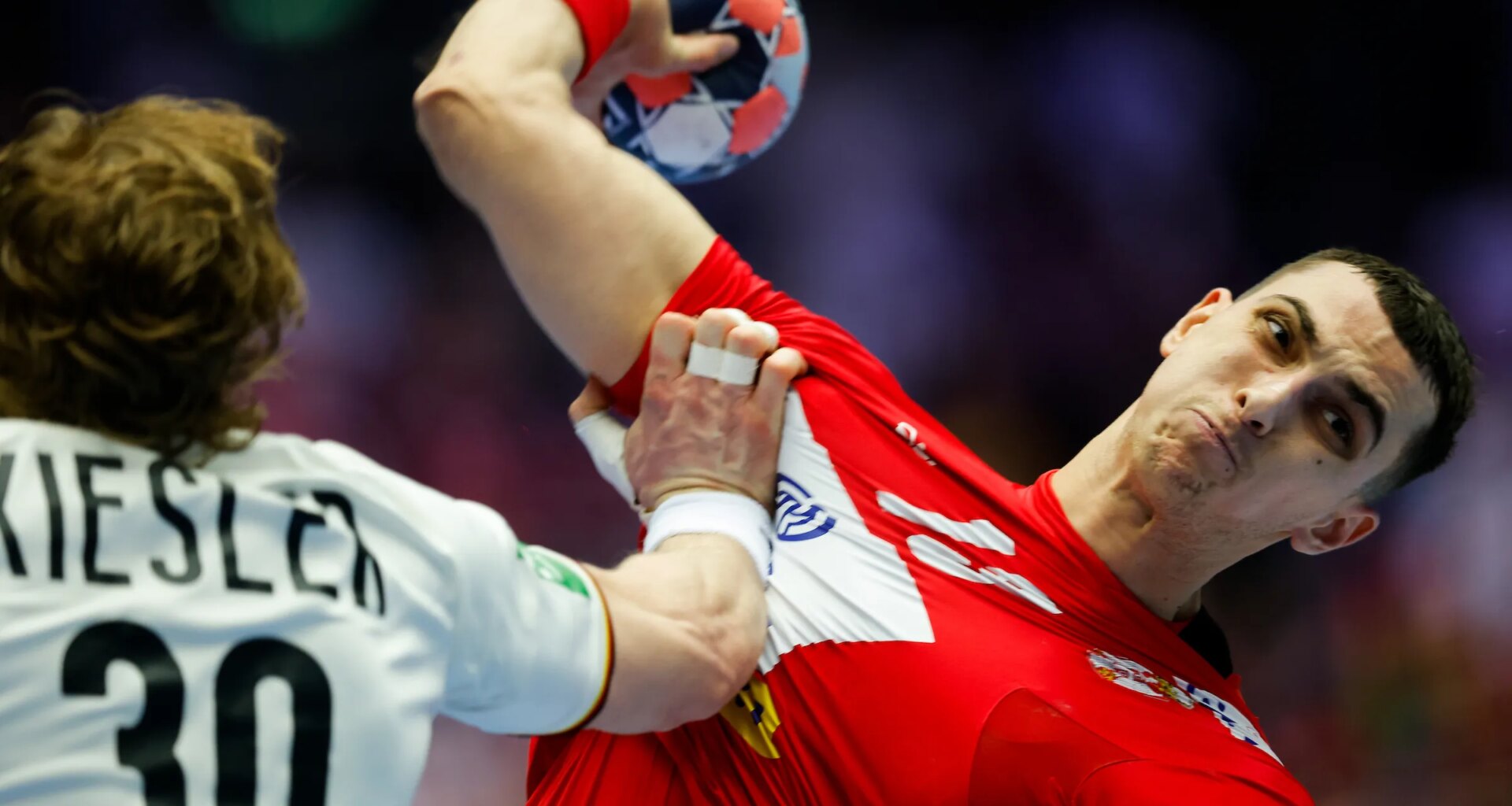 Serbia shock Germany to remain in main round race