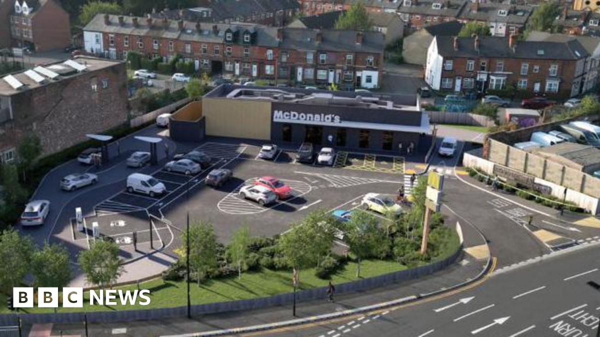 Prime Minister Mark Carney, wearing a black suit jacket, and a white button-up shirt leans his chin on his hands. He has short grey and black hair and is looking away from the camera.