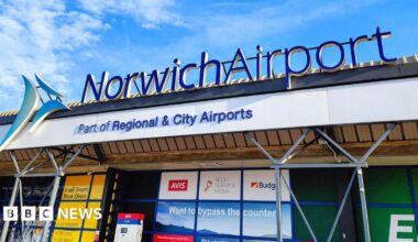 A sign saying 'Norwich Airport. Part of Regional and City Airports'