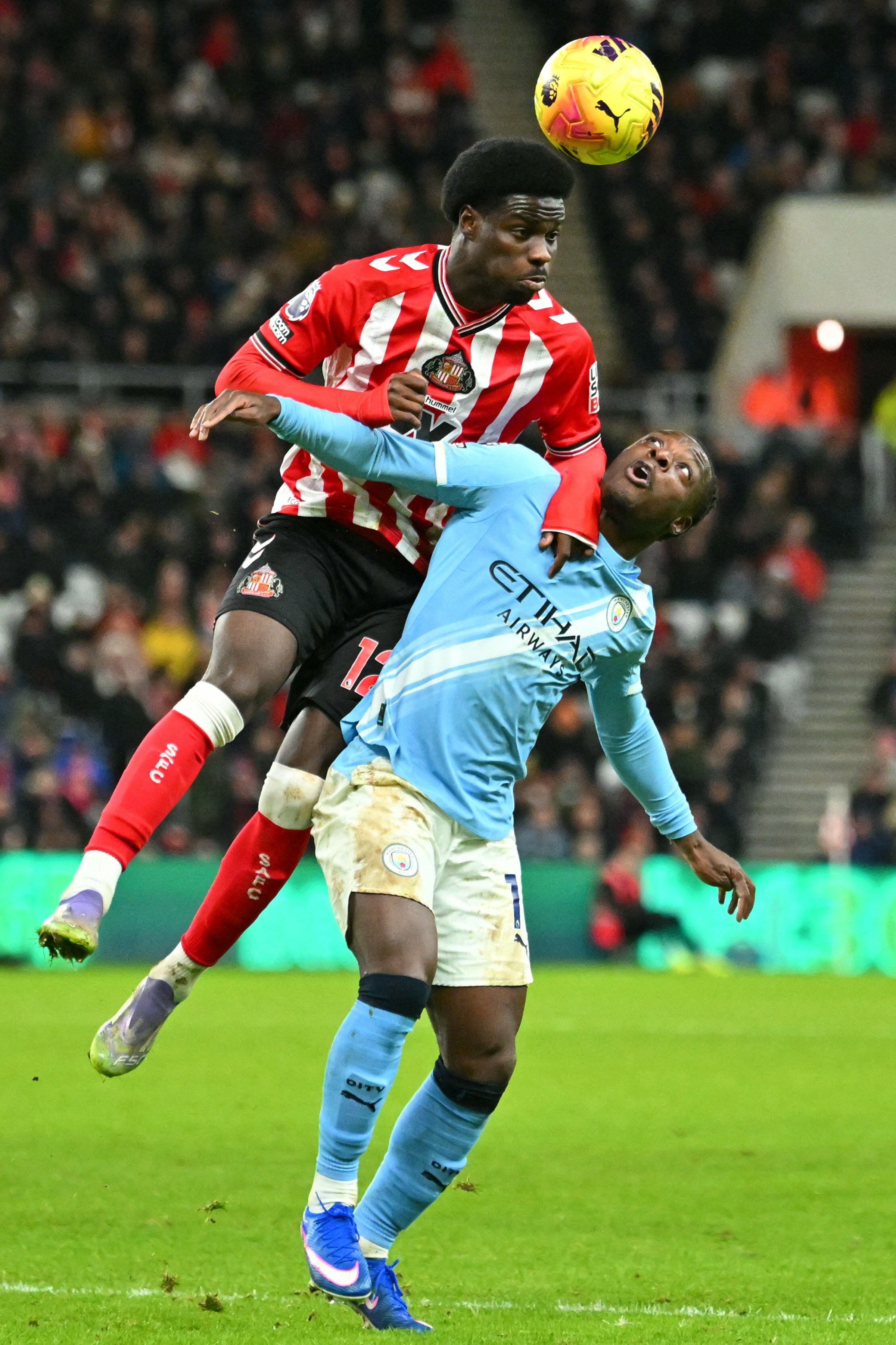 Sunderland’s Spanish striker #12 Eliezer Mayenda (L) jumps against Manchester City’s Belgian midfielder #11 Jeremy Doku (R) during the English Premier League football match between Sunderland and Manchester City at The Stadium of Light in Sunderland in north east England on January 1, 2026. (Photo by ANDY BUCHANAN / AFP via Getty Images) / RESTRICTED TO EDITORIAL USE. No use with unauthorized audio, video, data, fixture lists, club/league logos or ‘live’ services. Online in-match use limited to 120 images. An additional 40 images may be used in extra time. No video emulation. Social media in-match use limited to 120 images. An additional 40 images may be used in extra time. No use in betting publications, games or single club/league/player publications. /