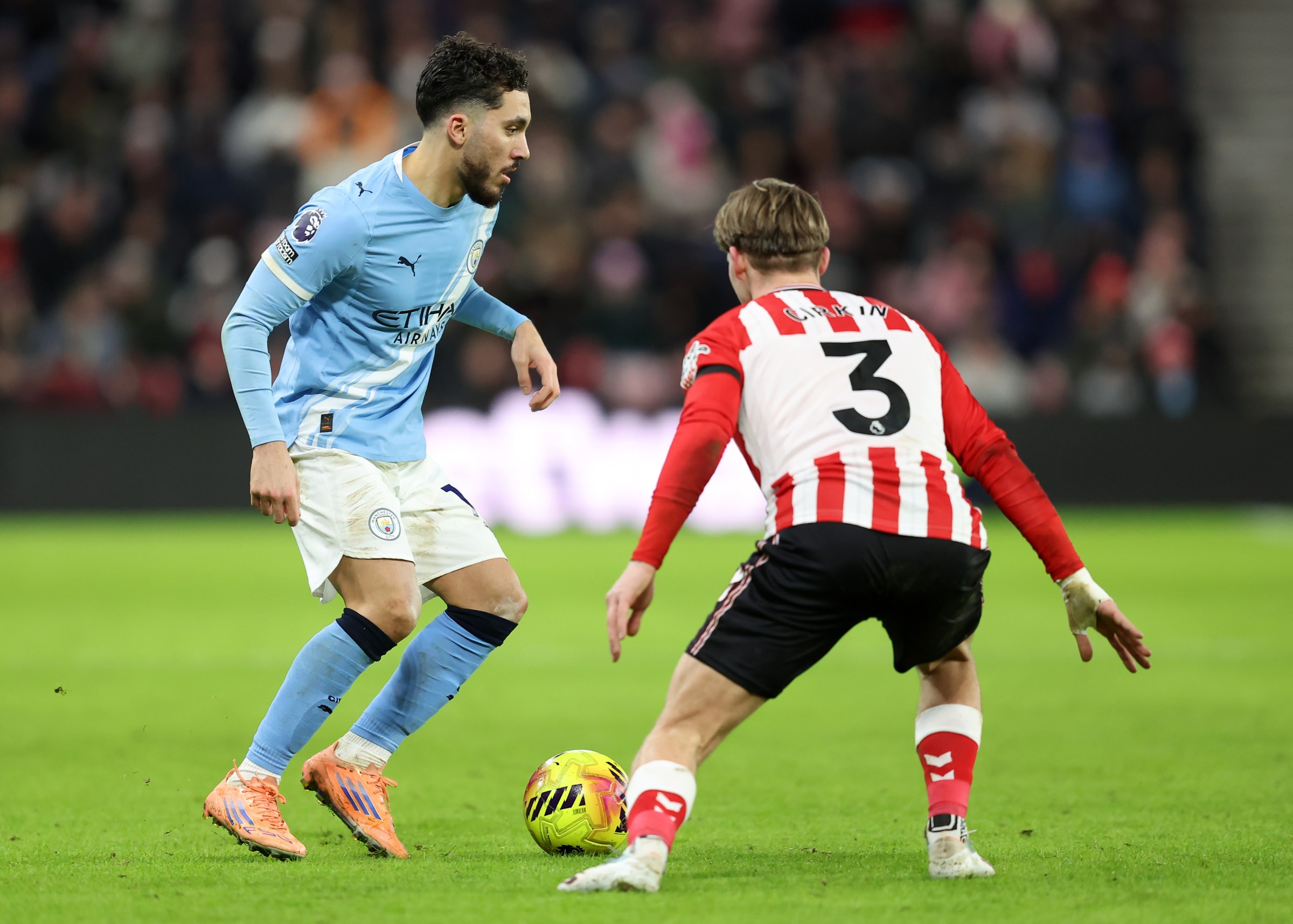 SUNDERLAND, ENGLAND - JANUARY 01: Rayan Cherki of Manchester City is put under pressure by Dennis Cirkin of Sunderland during the Premier League match between Sunderland and Manchester City at Stadium of Light on January 01, 2026 in Sunderland, England. (Photo by Matt McNulty/Getty Images)