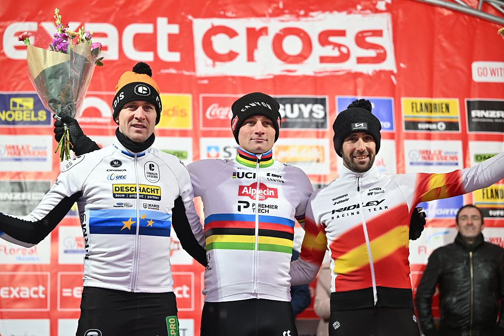 (FROM L) Second placed Belgian Toon Aerts, first placed Dutch Mathieu Van Der Poel and third placed Spanish Felipe Orts Lloret celebrate on the podium after the men's elite race of the Zilvermeercross cyclocross cycling event, stage 5 out of 7 in the Exact Cross competition, in Mol on January 2, 2026. (Photo by LUC CLAESSEN / Belga / AFP) / Belgium OUT