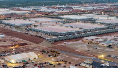 Rows of large, low buildings and construction vehicles at the Stargate AI data center site in Abilene, Texas.