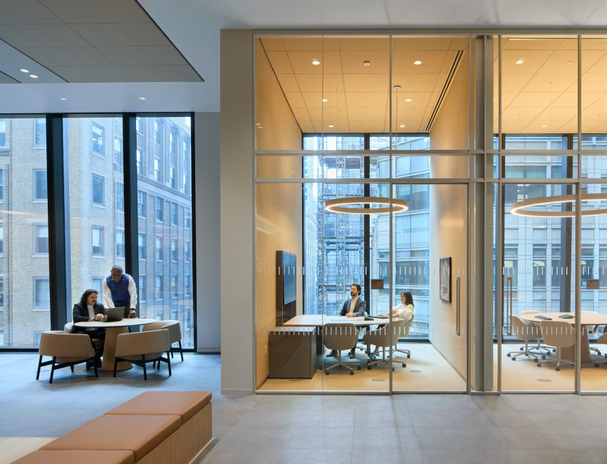 Small meeting rooms and huddle spaces along a glass perimeter