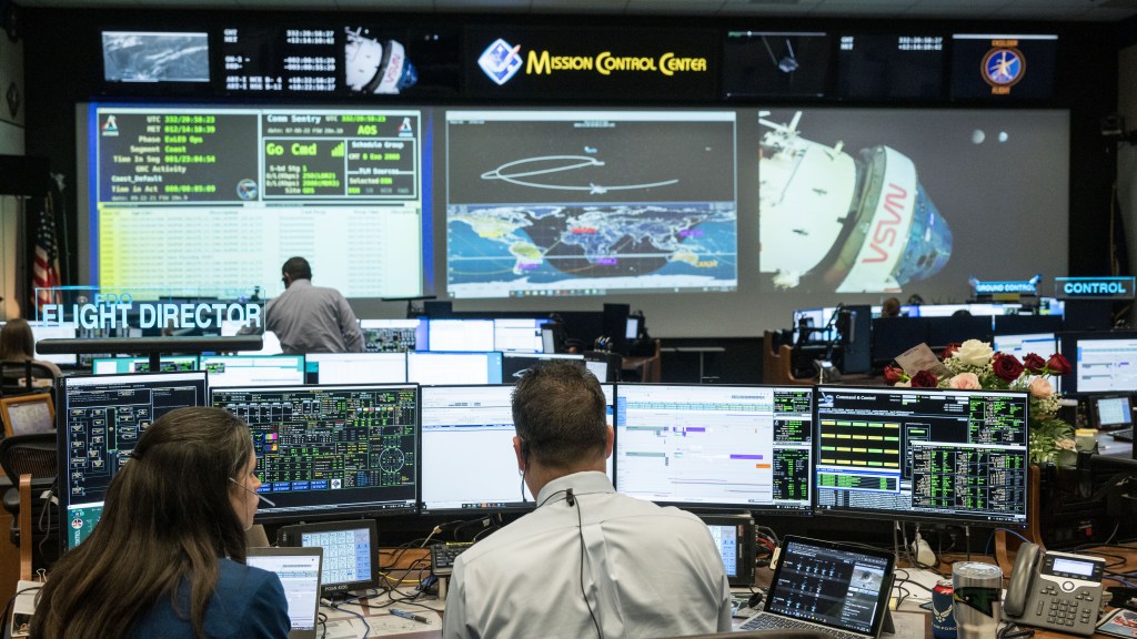Flight Directors Paul Konyha and Nicole McElroy monitor the Orion spacecraft as it reaches its record-breaking distance from the Earth, nearly 270,000 miles, on flight day 14 of the Artemis I mission. Credit: NASA/Robert Markowitz