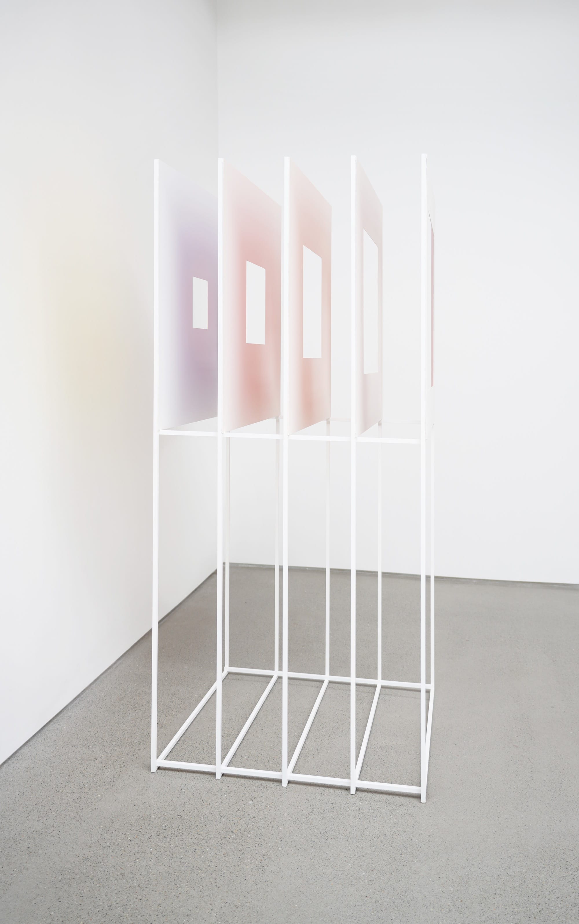 a standing sculpture of white panels with color on the backs by Luftwerk