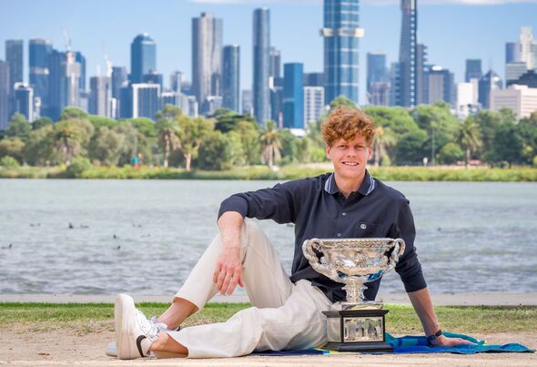 Jannik Sinner poses with a trophy in Melbourne