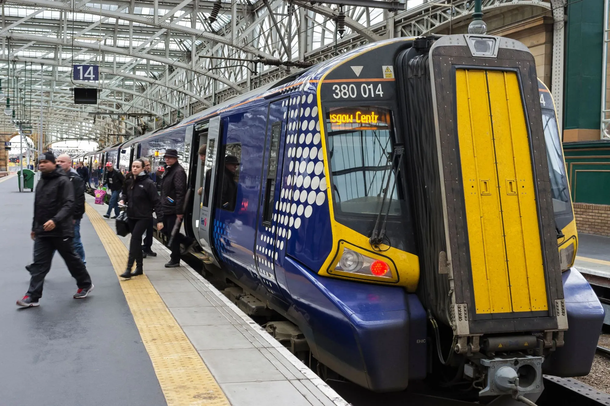 An image collage containing 1 images, Image 1 shows Passengers getting off an intercity train at Glasgow Central Railway station