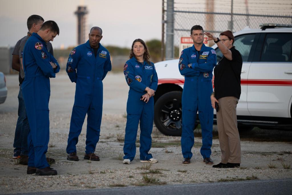 Charlie Blackwell-Thompson, Artemis II Launch Director, right, talks to NASA astronauts Reid Wiseman, Artemis II commander, second from right, Christina Koch, Artemis II mission specialist, Victor Glover, Artemis II pilot, and CSA (Canadian Space Agency) astronaut Jeremy Hansen, as teams at NASA's Kennedy Space Center in Florida practiced various emergency rescue training scenarios with the Artemis II crew, Friday, Dec. 19, 2025, ahead of the Artemis II mission. In the unlikely event of an emergency during launch countdown at Launch Complex 39B, personnel will be transported in mine-resistant ambush protected vehicles, or MRAPS, from the pad and to one of the triage site locations at Kennedy. Photo Credit: (NASA/Joel Kowsky)