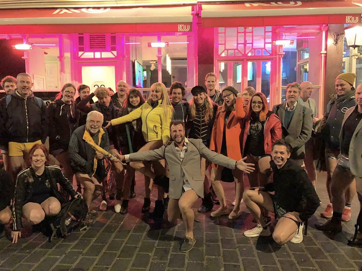 a trouserless group of people posing for a photo after the no trousers tube ride 2023