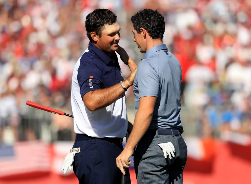 Patrick Reed of the United States shakes hands with Rory McIlroy of Europe after Reed won their match during singles matches of the 2016 Ryder Cup at Hazeltine National Golf Club on October 2, 2016 in Chaska, Minnesota.