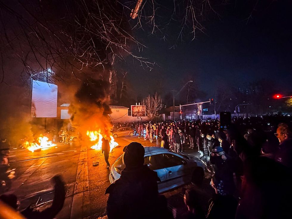 Protesters set cars alight in Iran