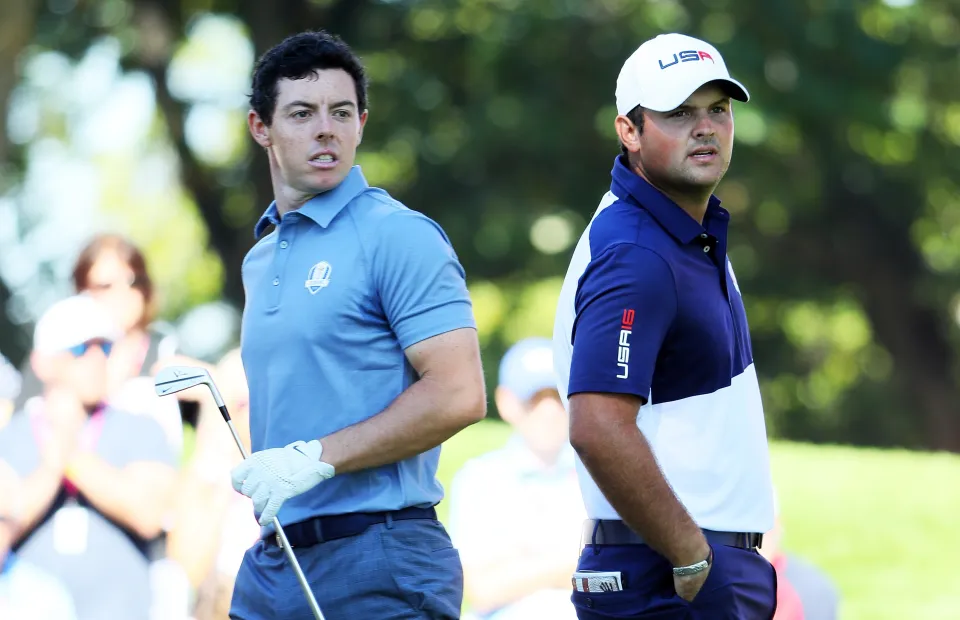 Rory McIlroy of Europe and Patrick Reed of the United States look on from the fourth tee during singles matches of the 2016 Ryder Cup at Hazeltine National Golf Club on October 2, 2016 in Chaska, Minnesota.