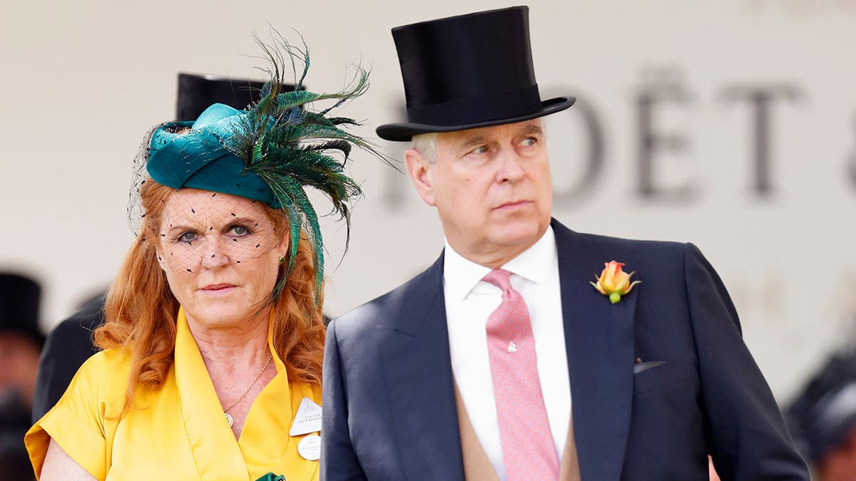 Sarah Ferguson and ex-Prince Andrew in formal wear with fancy hats looking concerned outdoors.