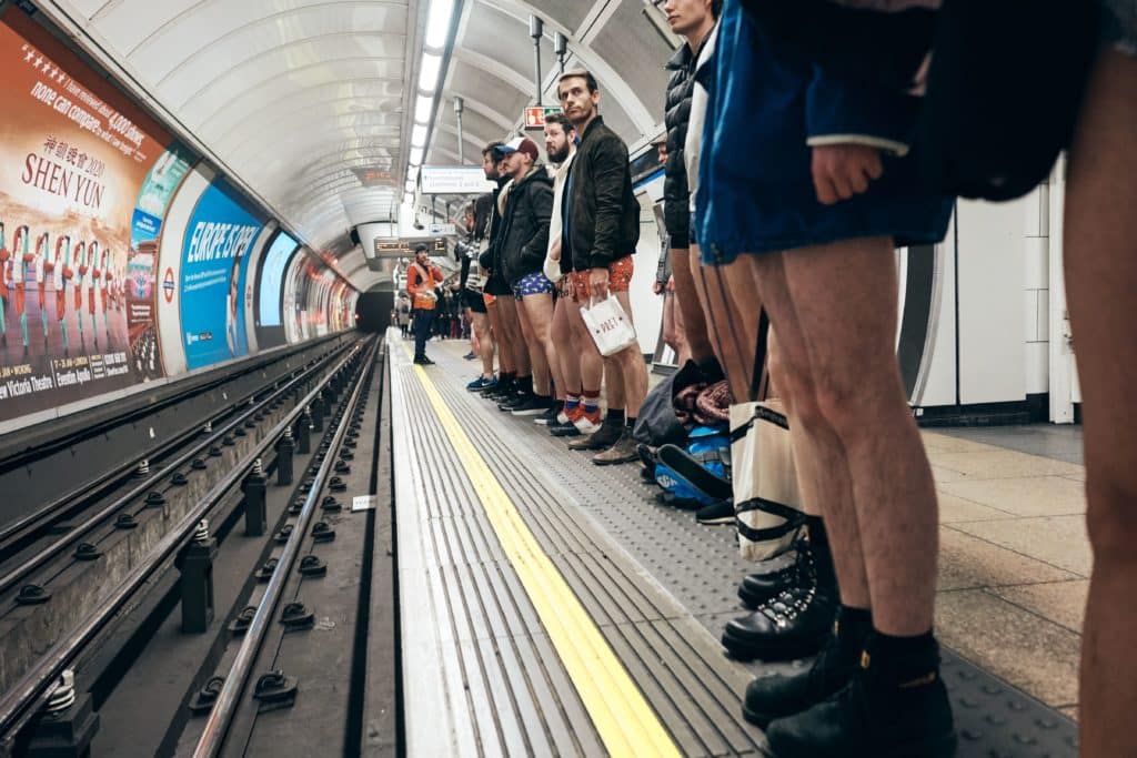 people stood waiting for the tube, all noticeably without any trousers on, for the no trousers tube ride in January