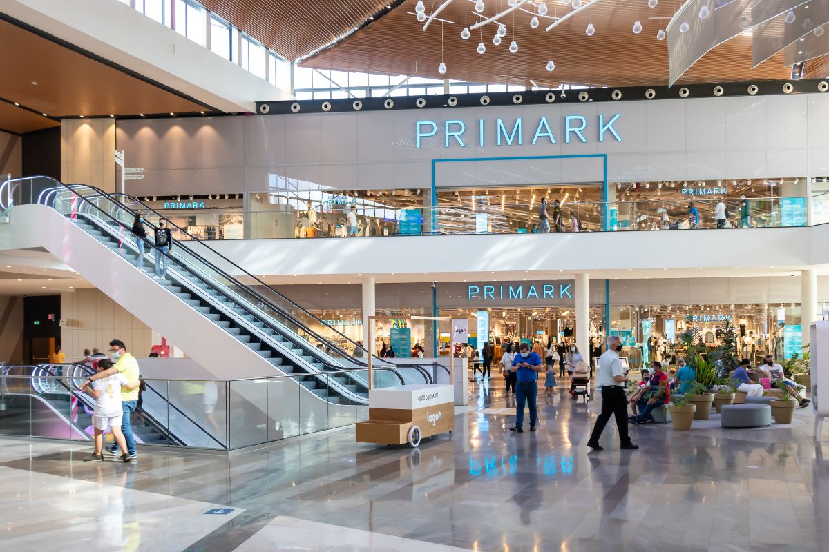 people walking past a Primark store in a shopping centre