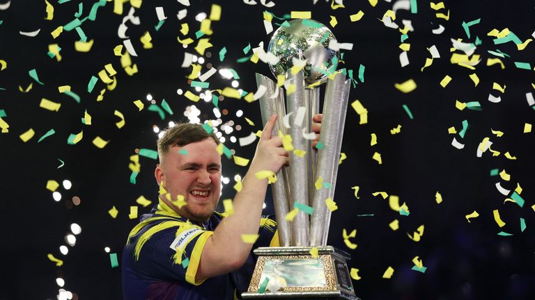 Littler celebrating with the Sid Waddell trophy. Pic: Reuters