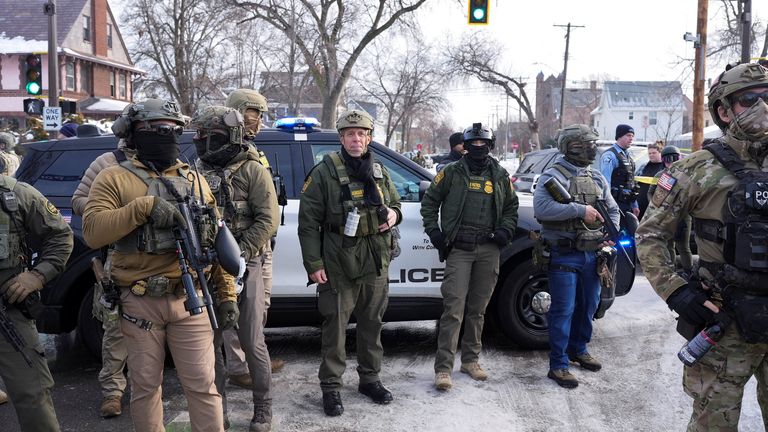 Members of ICE stand guard after a driver of a vehicle was shot in Minneapolis. Pic: Reuters