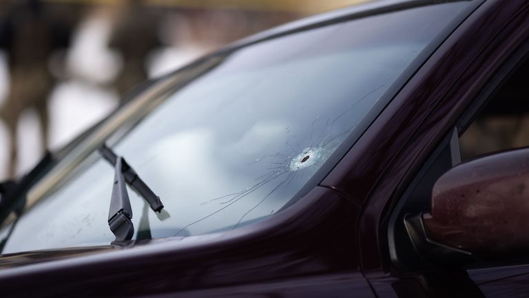 A bullet hole is seen on the windshield of the vehicle. Pic: AP