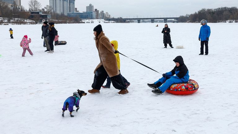 People playing on the frozen Dnipro river in Kyiv. Pic: Reuters