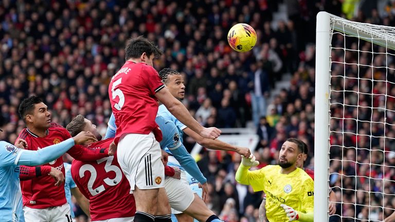 Harry Maguire heads against the bar at close range (AP Photo/Dave Thompson)