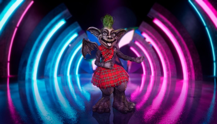 ©ITV Plc Someone dressed as a Gargoyle in red plaid clothing.