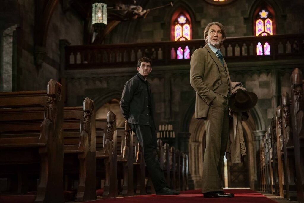 daniel craig and josh o'connor as seen in a still from 'wake up dead man' - standing inside a church